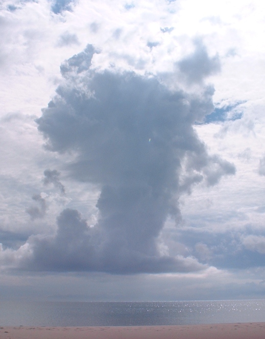 Towering thunderheads over Lake Michigan, sand beach in foreground